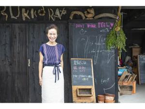 a woman standing in front of a blackboard at Dan Hiyori - Vacation STAY 08978v in Ebino