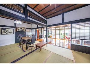 a dining room with a table and chairs and windows at Dan Hiyori - Vacation STAY 08978v in Ebino