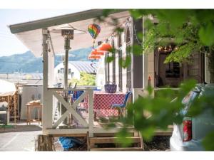 a porch with a table and a hot air balloon at Nikko Park Lodge - Vacation STAY 15306v in Nikko