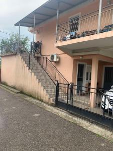 a building with a balcony and stairs on it at NIKOLA s HOUSE in Podgorica