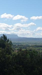 a view of a valley with mountains and trees at Les Cigales in Villelaure