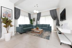 een woonkamer met twee blauwe banken en een salontafel bij Villa 10 Palmeraie Golf Agadir in Agadir
