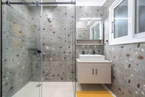 a bathroom with a shower and a sink at Ano Patisia Station Studio in Athens