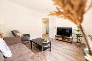 a living room with a couch and a tv at Ferienhaus Scheid in Bremm