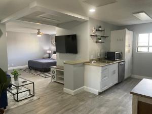 a living room with a kitchen and a bedroom at Sunny Palms Inn in Lake Worth