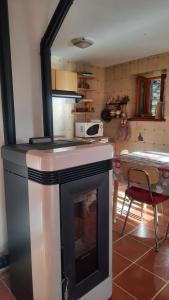 a kitchen with a stove with a fireplace at Casa Indipendente Val d'Ayas - Challand Saint Anselme in Challand Saint Anselme