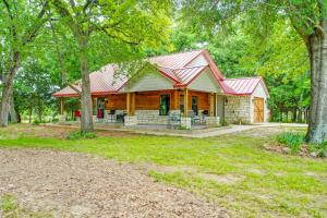 a log home with a red roof at Wills Point Vacation Rental on 10 Acres of Land! in Canton