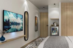 a bedroom with a large tv on the wall at Erzurumlu Hotel in Kilyos