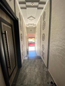 a hallway leading to a room with a door at Bouznika in Bouznika