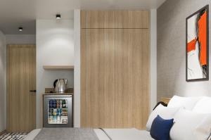 a room with a refrigerator and a bed in it at Erzurumlu Hotel in Kilyos