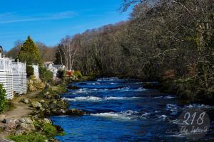 a river with rapids on the side of it at The Cabin, Glan Gwna in Caernarfon