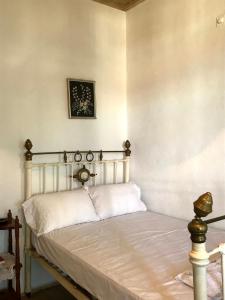 a bedroom with a bed with a white bedspread at Villa Elli 