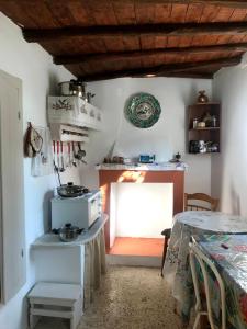 a kitchen with a stove and a table in a room at Villa Elli 