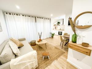 a living room with a couch and a table at El Olivo by ALÔGA in Corcubión