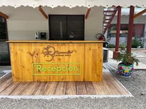 a wooden bar with a television on top of it at Manzanillo Caribbean Resort in Puerto Viejo