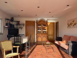 a living room with a couch and a table at La Casina de Iris in Cudillero