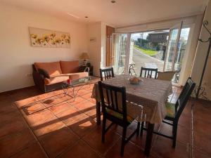 a living room with a table and a couch at La Casina de Iris in Cudillero