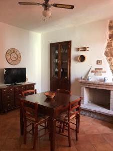 une salle à manger avec une table et une cheminée dans l'établissement CASA VACANZE "SU PORTALE", à Gonnesa