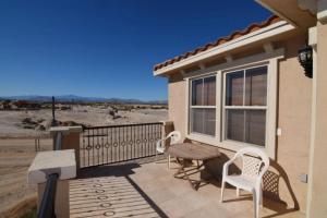 a patio with a table and chairs on a balcony at Condo 19-3 Family Vacation Condo on the Sea of Cortez pools tennis and golf in Playa El Paraíso