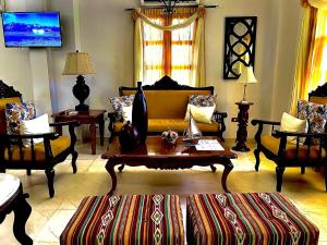a living room with couches and a coffee table at Hotel Dorado Plaza Calle del Arsenal in Cartagena de Indias