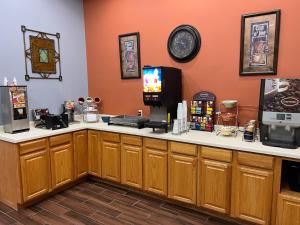 a counter in a coffee shop with a tv on it at GrandStay Hotel and Suite Waseca in Waseca