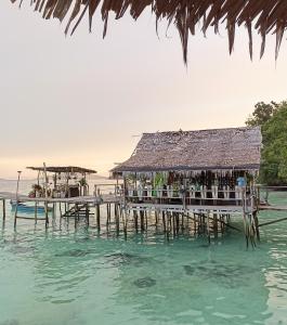a restaurant on a pier in the water at Yenbainus homestay in Yennanas Besir