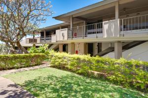 an apartment building with a lawn in front of it at Maui Eldorado E106 in Kahana