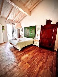 a bedroom with a bed and a wooden floor at Welcome Traveller VILLA ARIGONI in Garda