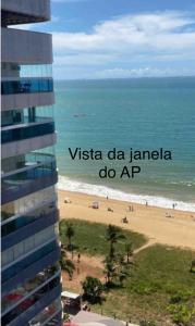 un edificio junto a una playa con las palabras vista da la karma do ap en Pé na areia Praia da Costa, en Vila Velha