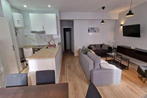 a kitchen and living room with a couch and a table at Loft en Madrid junto al metro. in Madrid