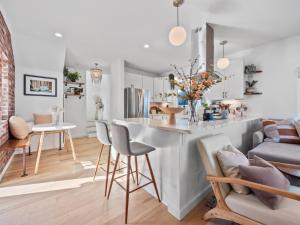 a kitchen and living room with a counter and chairs at Beach Essentials&bikes - Backyard&patios in San Diego