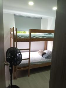 a room with two bunk beds and a fan at Hermoso para estrenar in Cali