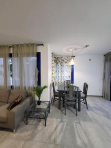 a living room with a couch and a table and chairs at Waikiki 47 in Corralejo