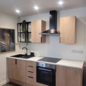 a kitchen with a sink and a stove top oven at No 1 The Terrace in Rainhull