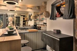 une cuisine avec un évier et un comptoir avec des tabourets dans l'établissement City Center Studio Nest, à Makarska