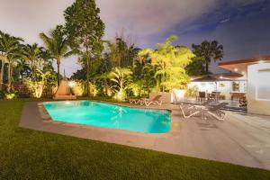a swimming pool in the yard of a house at Cool Villa Northwest Miami BY THE GLAMHOMES in Miami