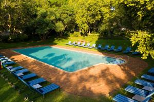 an overhead view of a swimming pool with lounge chairs at Mount Grace Hotel & Spa in Magaliesburg