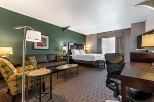 a hotel room with a couch and a bed at Best Western Plus Duncanville/Dallas in Duncanville