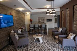 a lobby with couches and a table and a bar at Candlewood Suites Sheridan, an IHG Hotel in Sheridan
