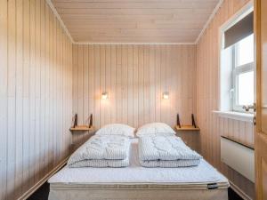 two beds in a room with wooden walls at Holiday home Tarm XL in Tarm