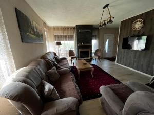 a living room with a couch and a fireplace at Villa Peisazhi in Ferizaj