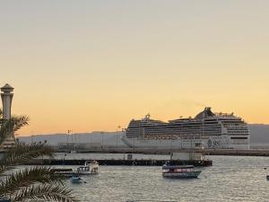 a cruise ship docked at a dock in the water at Al-Amer Hostel 2 in Aqaba