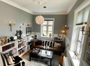 a living room with a couch and a guitar at The Foreman house - an authentic town center Villa in Húsavík