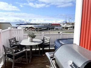a patio with a table and chairs on a balcony at The Foreman house - an authentic town center Villa in Húsavík