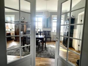 a living room with a dining room table and a door at The Foreman house - an authentic town center Villa in Húsavík