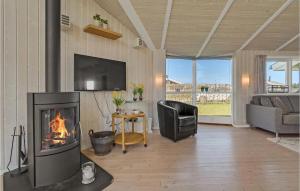 a living room with a fireplace and a television at Cozy Home In Haderslev With Sauna in Haderslev