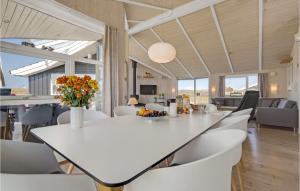 a dining room and living room with a white table and chairs at Cozy Home In Haderslev With Sauna in Haderslev