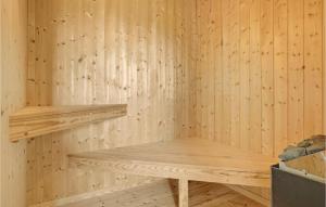 a sauna with wooden walls and wooden shelves at Cozy Home In Haderslev With Sauna in Haderslev