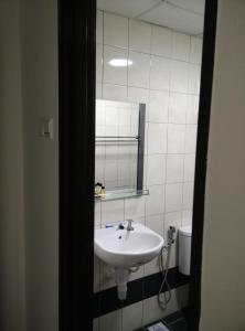 a bathroom with a sink and a mirror at Indah Alam Condo in Shah Alam