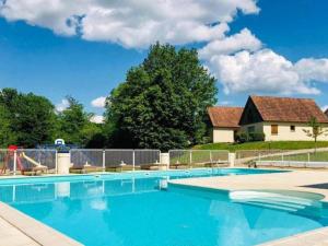 a swimming pool with chairs and a house at Lac Bleu 16 in Lacapelle-Marival
